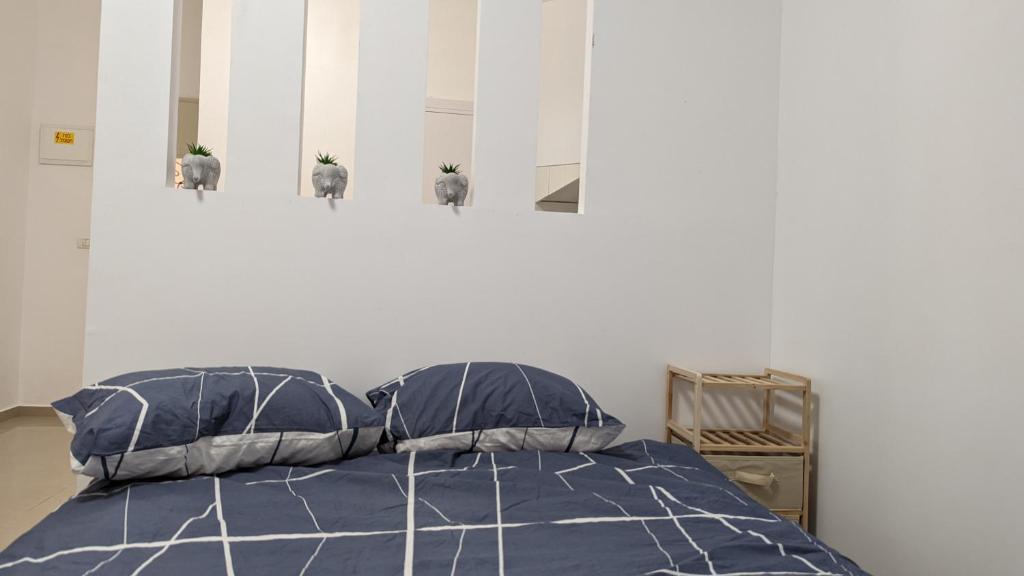 Beʼer OraThe Brill'S - הברילים的一间卧室配有一张带蓝色棉被和枕头的床
