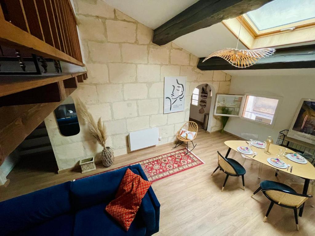 阿尔勒Duplex de charme 80m2 au coeur d'Arles, 2 chambres的客厅配有蓝色的沙发和桌子