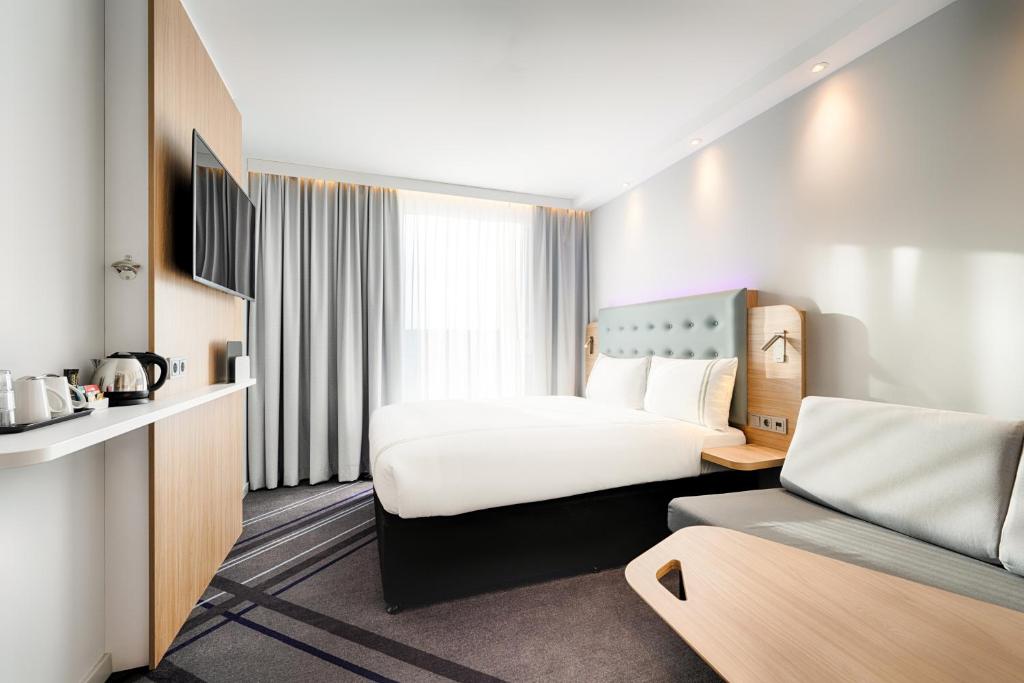 莱比锡Premier Inn Leipzig City Hahnekamm的酒店客房设有一张大床,