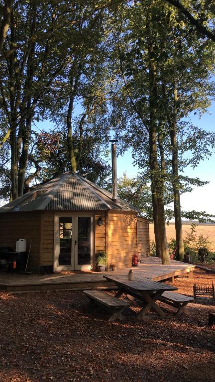 金斯林Woodpecker Cabin with Hot tub的小屋前方设有野餐桌