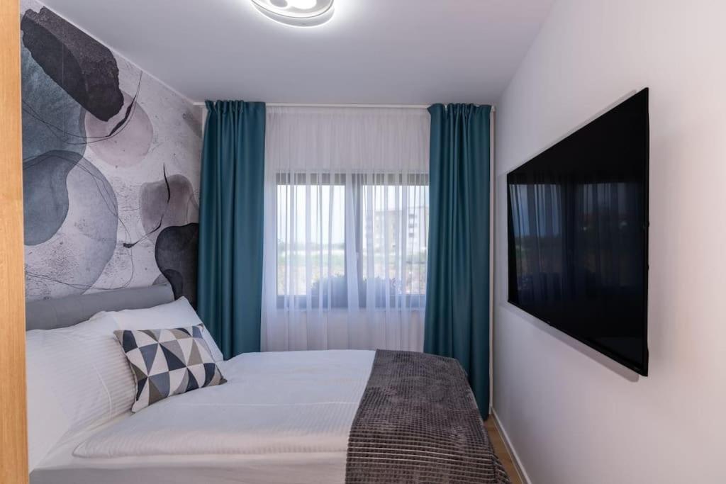 乌马格Capsula Luxury Apartment Umag的一间卧室配有一张床和一台平面电视