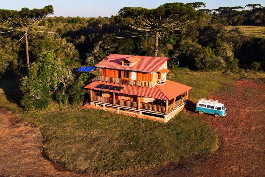TurvoPousada Ninho da Gralha的房屋前面有一辆面包车,享有高空的景色