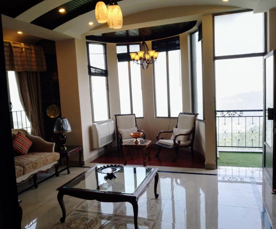 Khaira GaliNoor Villa的带沙发、椅子和窗户的客厅