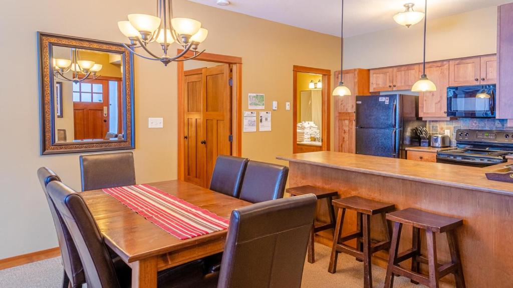 太阳峰Settlers Crossing #61 by Bear Country的厨房以及带木桌和椅子的用餐室。