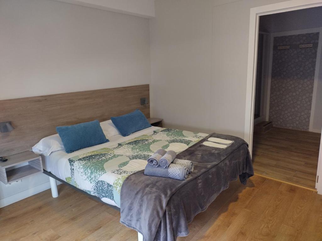 圣地亚哥－德孔波斯特拉Pensión Casa Douro的一间卧室配有一张床,上面有两条毛巾
