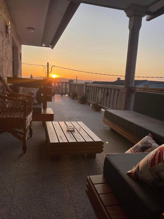 米亚诺Casa Arxon的一个带沙发和桌子的庭院,享有日落美景