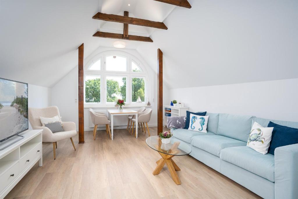 蒂门多弗施特兰德KUR18 Ferienwohnung Baltic Deck的客厅配有蓝色的沙发和桌子