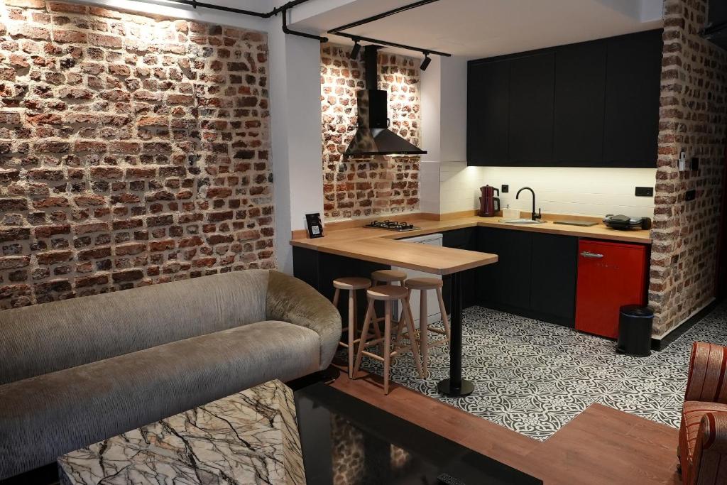 伊斯坦布尔Alness Residence的厨房设有酒吧和砖墙