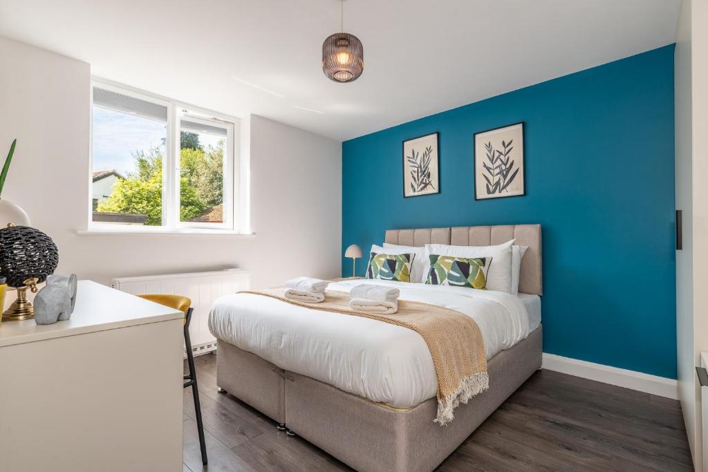 莱斯特Must See Vibrant Contemporary Two Bed Apartment的一间卧室设有蓝色墙和一张床