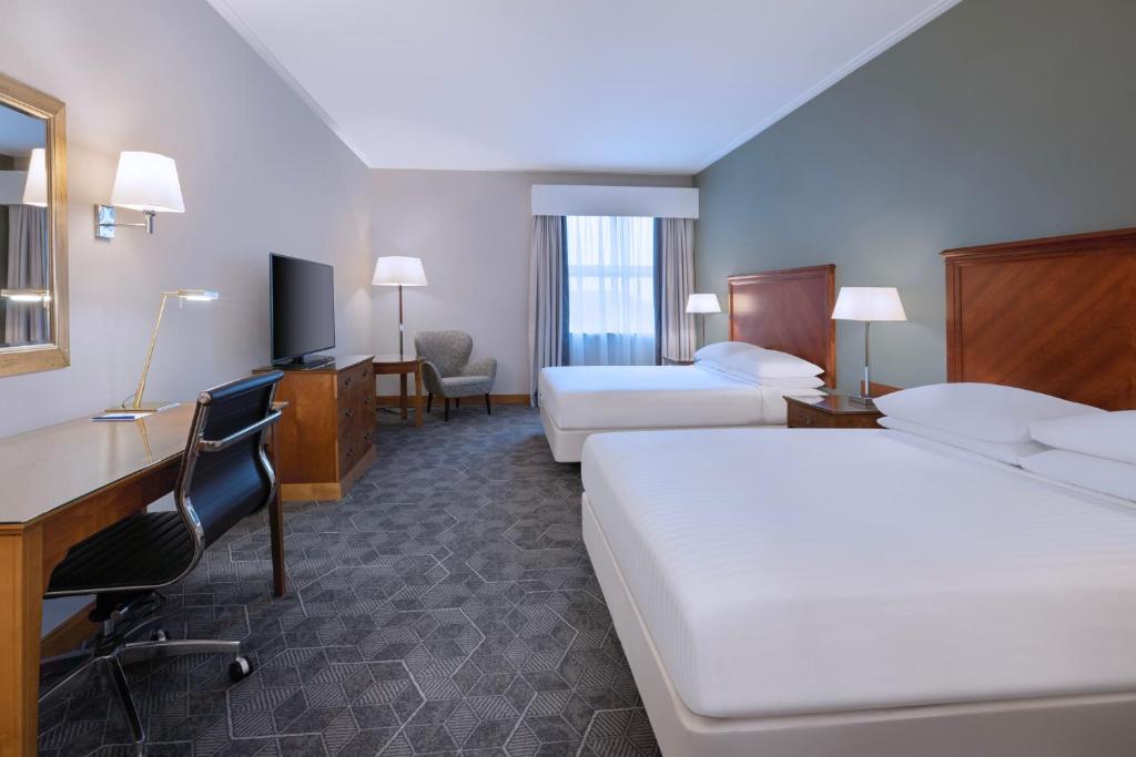 贝克斯利黑思Delta Hotels by Marriott Bexleyheath的酒店客房配有两张床和一张书桌