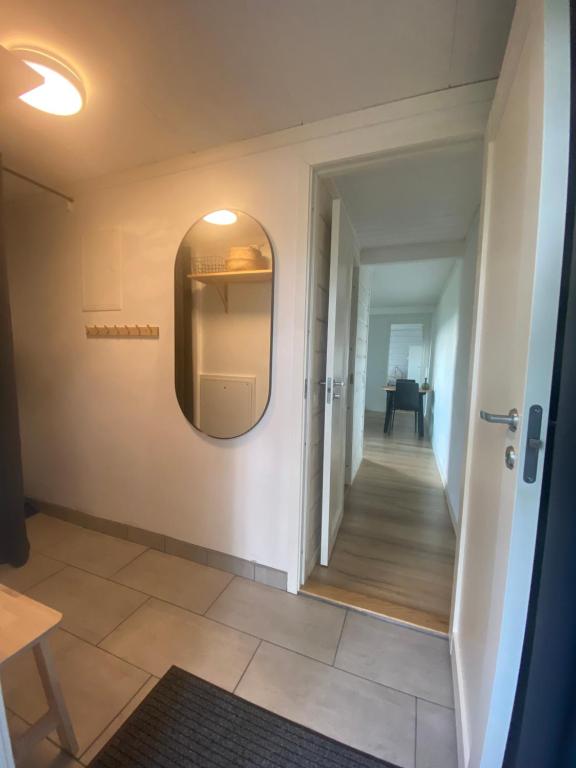 萨伦Mysig källarlägenhet i Lindvallen的走廊上设有门,墙上设有镜子