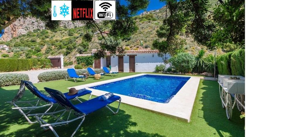 埃尔乔罗卡米尼托德雷乡村民宿的一个带椅子的庭院和房子的游泳池