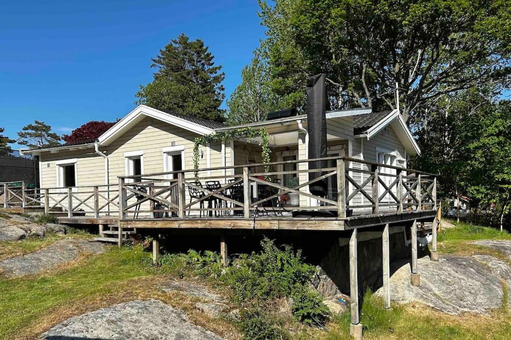 KullavikKullavik, 2 mil från Göteborg Villa Gläntan的白色的房子,在码头上设有木门廊