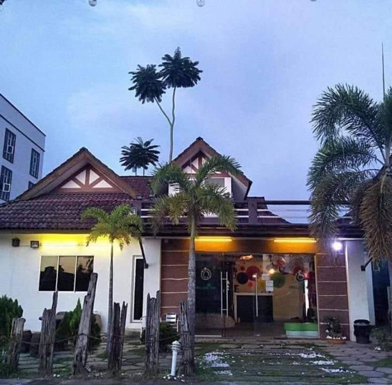 亚娄Kuu Inn Motel的前面有棕榈树的房子