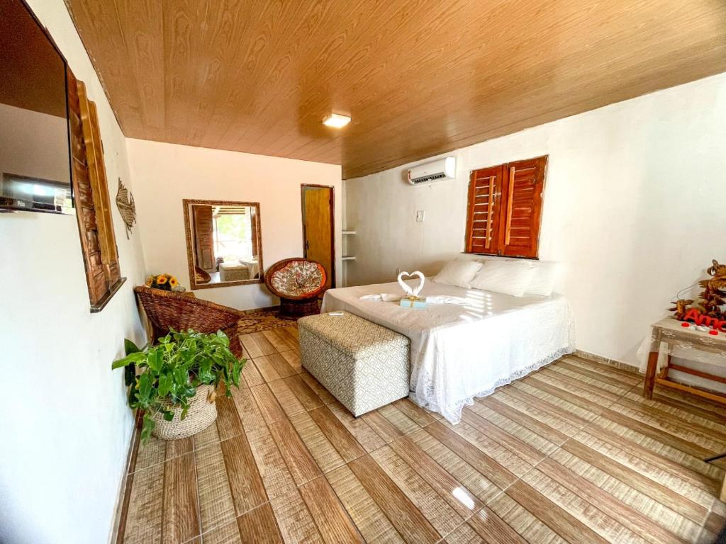 路易斯科雷亚Pousada Três Lagoas的一间卧室配有一张床、一把椅子和一张桌子