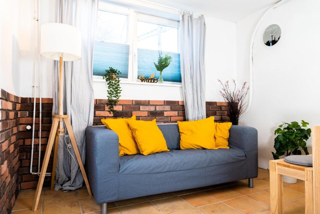 汉堡Spacious Apartment in urban location的客厅配有蓝色沙发及黄色枕头