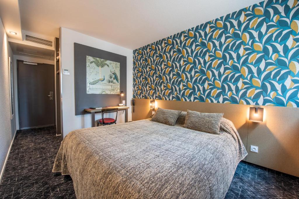 阿让Cit'Hotel Stim'Otel的一间卧室配有一张蓝色和黄色墙壁的床