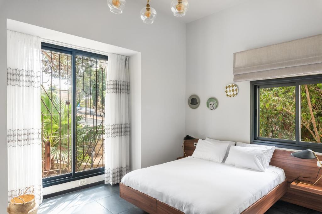 海法Carmel Suites by Olala Homes的一间卧室设有一张床和大窗户