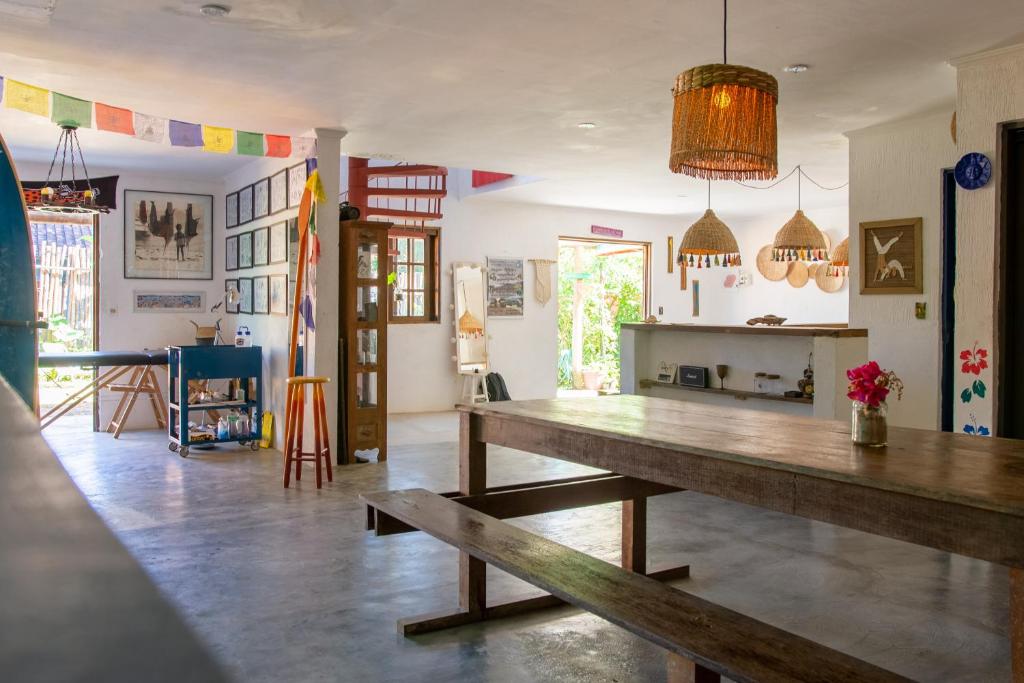 伊利亚贝拉Sambaqui Hostel的一间用餐室,在房间内配有木桌
