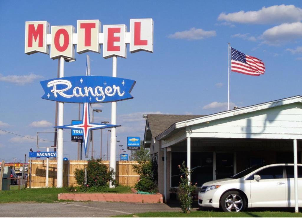 El RenoRanger Motel的汽车经销商前面的汽车旅馆标志