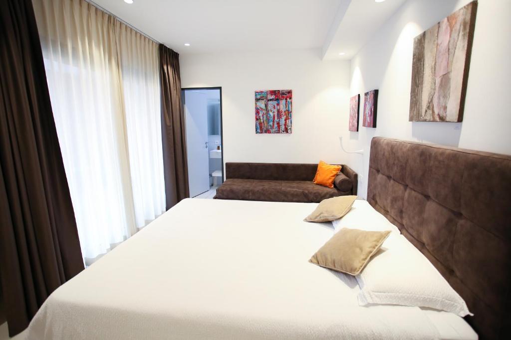 洛迦诺Hotel Bellavista Locarno的卧室设有一张白色大床和一扇窗户。