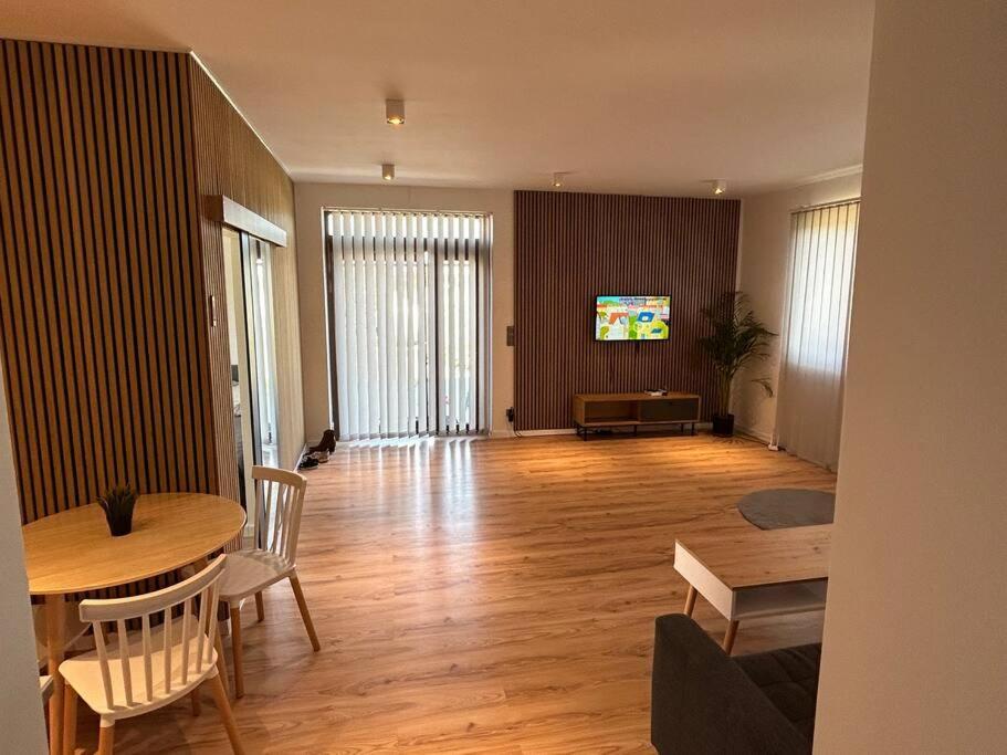 Luxury 2 bedroom apartment and garden的客厅配有桌椅和电视。