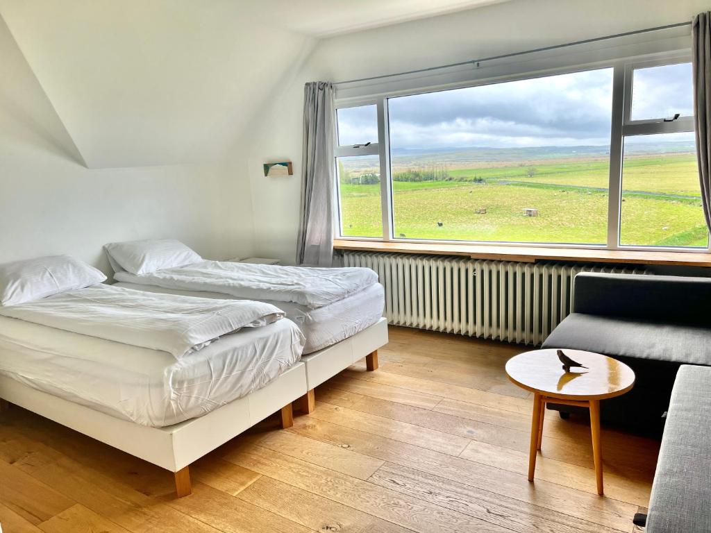 KjarnholtMengi Countryside的一间卧室设有床、窗户和沙发