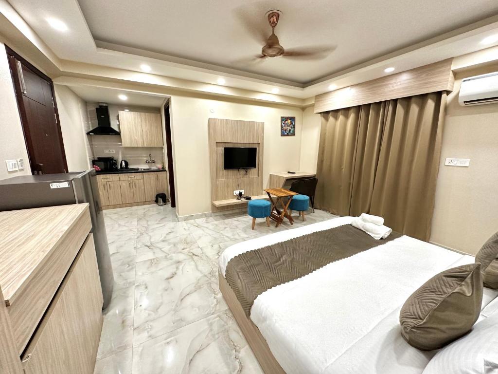 古尔冈Paras Studios By The Lodgers-Serviced Apartments Near Artemis Hospital Gurgaon的一间带大床的卧室和一间厨房