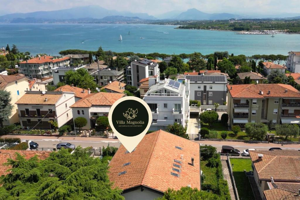 佩斯基耶拉德加达Appartamento 2, Villa Magnolia, 64mq, Lago di Garda的享有小镇的景色,在建筑的顶部有标志