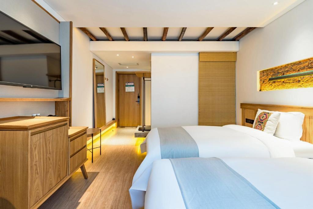 Yoba Boutique Hotel客房内的一张或多张床位