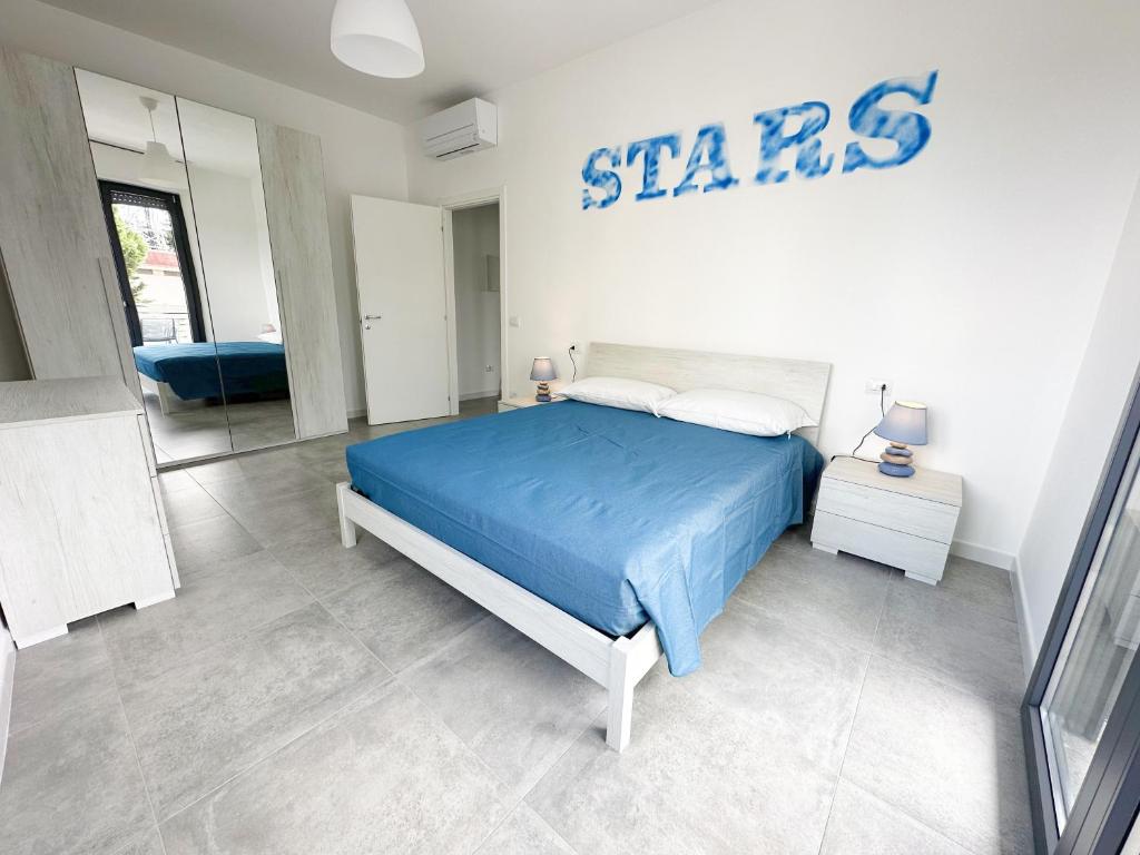福洛尼卡LUX apartments T的卧室配有蓝色的床和墙上的标志