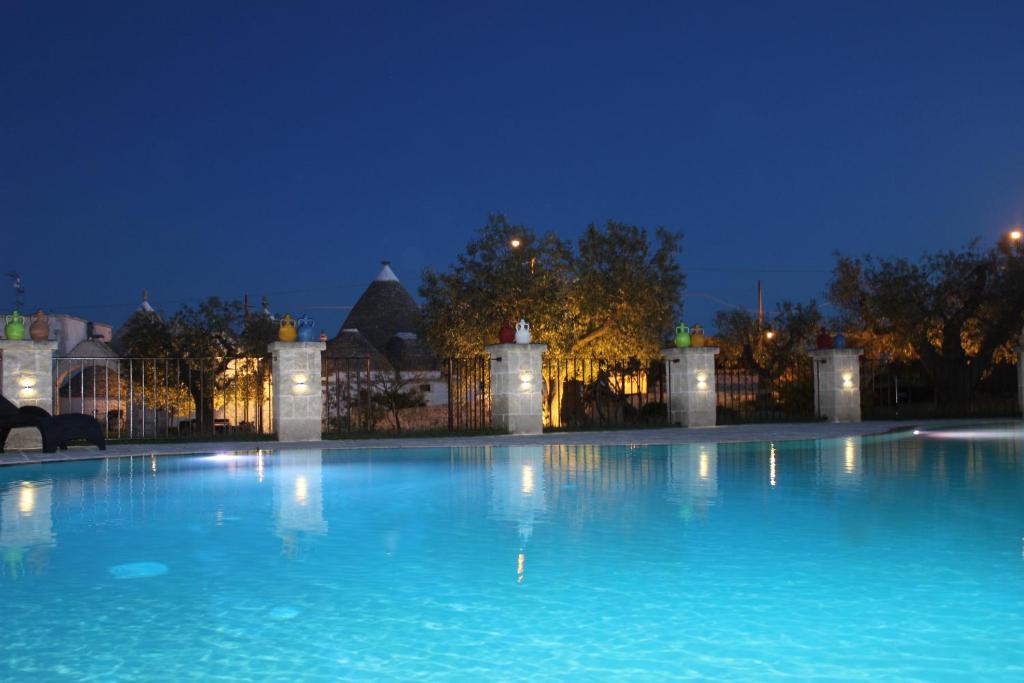 阿尔贝罗贝洛格贝洛塔公寓式度假酒店的一座大楼前的大型游泳池