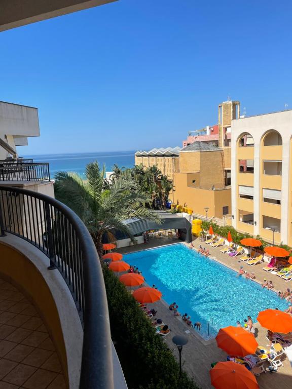 加利波利appartamento vista mare da MARY的享有带橘子伞的游泳池和大海的景致