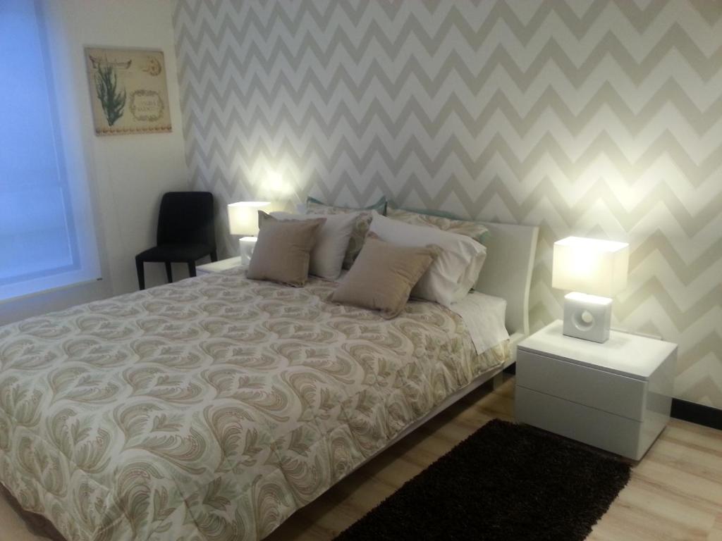 基多Suites Metropoli Bristol Parc的一间卧室配有一张带长沙发的大床