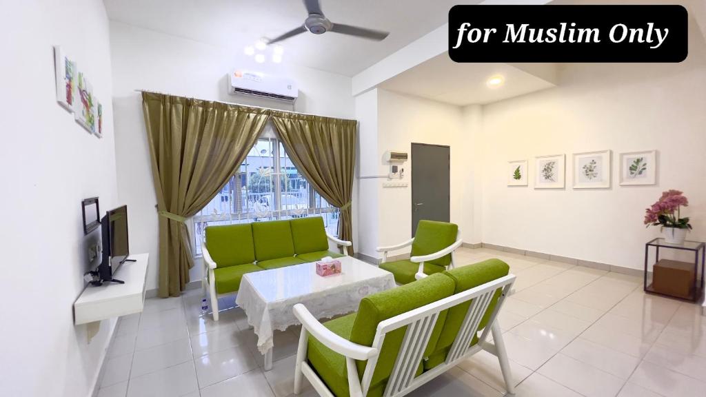 Kampong BesutDe Qasturee KLIA@Kota Warisan homestay nearest to airport的客厅配有绿色沙发和桌子