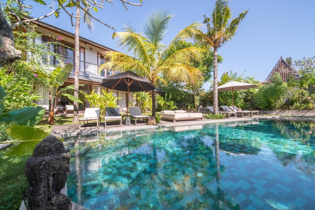 坎古MASMARA Resort Canggu的棕榈树度假村的游泳池