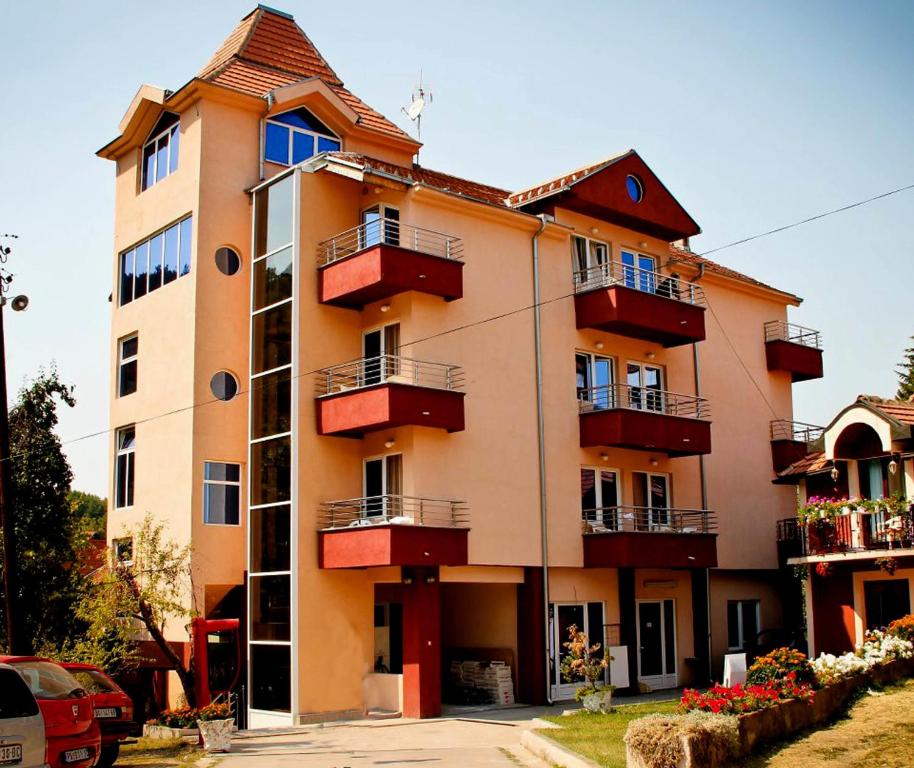 Prolomska BanjaSpa & wellness Villa Garetov Konak的街道上一座带红色阳台的大型建筑