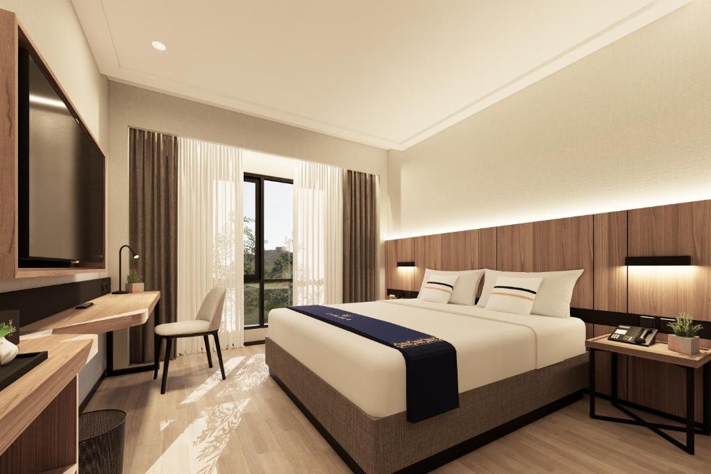 DawuhanFieris Hotel & Convention Kertajati的酒店客房,配有床和电视
