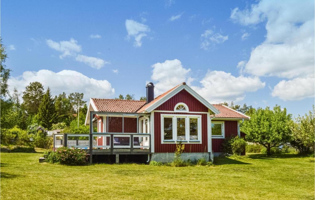 特鲁萨Beautiful Home In Trosa With Kitchen的草坪上带甲板的红色房子