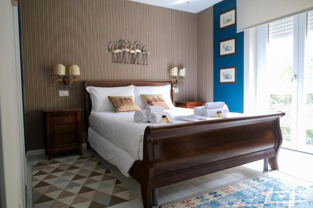 萨萨里Hermitage Suites的一间卧室配有一张大床和毛巾