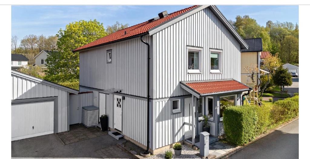 SurteModern and luxurious house -13 min by train from Gothenburg的白色的房子,设有大门和车库