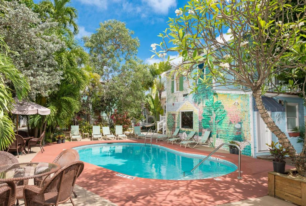 基韦斯特柳条宾馆的一个带椅子的庭院和房子的游泳池