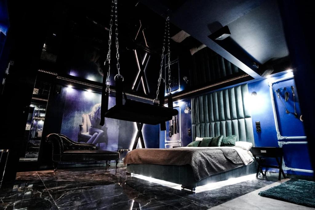 格但斯克Grey Aqua Secret Apartament的一间卧室设有蓝色的墙壁和一张带秋千的床