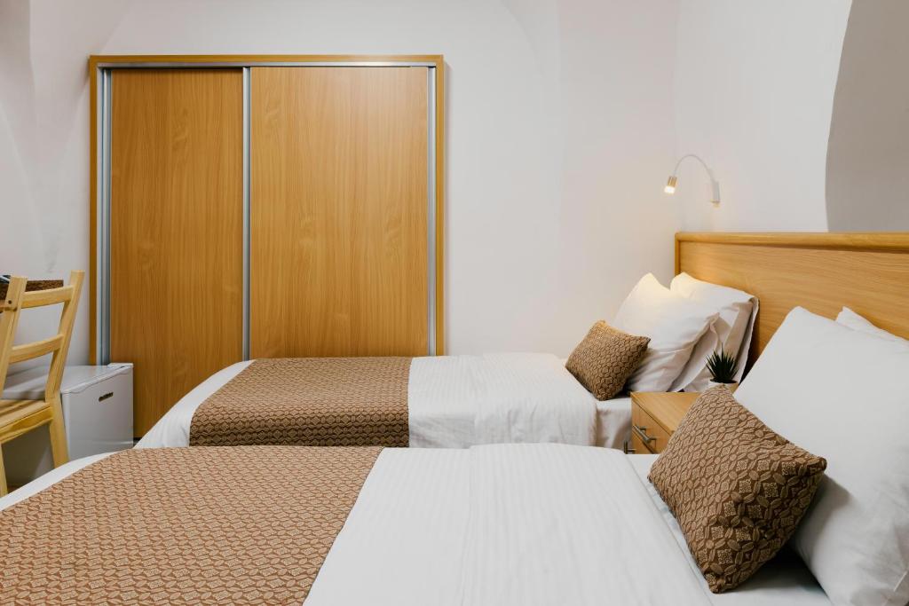 耶路撒冷William's Guest House的酒店客房设有两张床和一个衣柜。