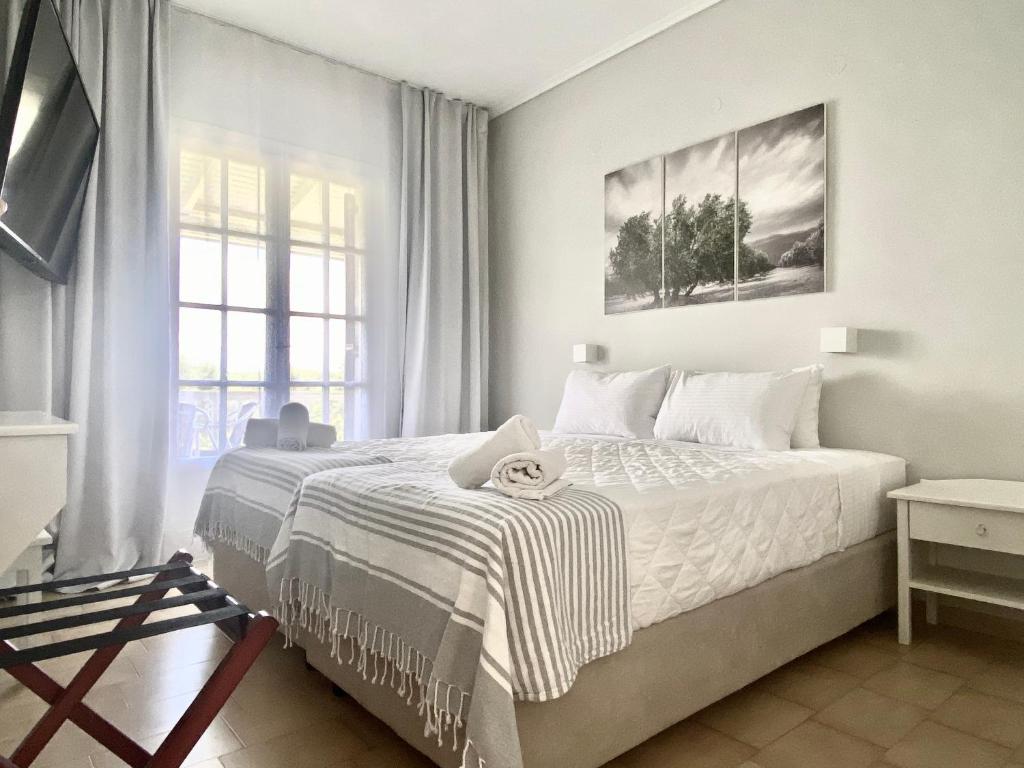 瓦西里科斯克莱莉亚别墅酒店的白色的卧室设有床和窗户