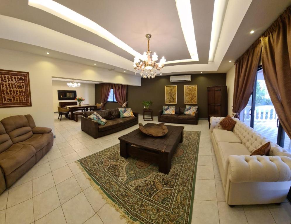BārbārLuxury holiday villas in Bahrain for Families的带沙发和吊灯的大型客厅