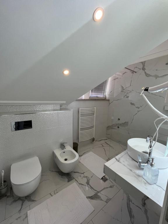 萨拉热窝Villa Luca的白色的浴室设有卫生间和水槽。