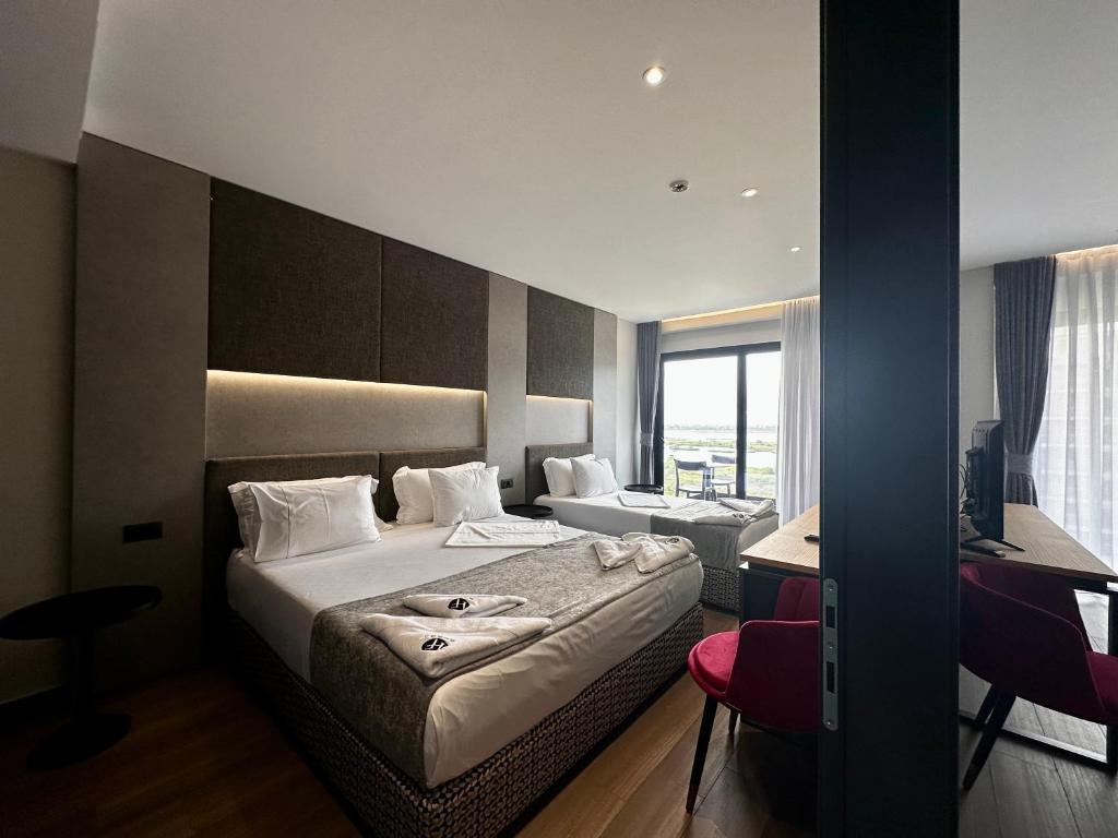 圣金Frojd Kune Resort & Beach Hotel的配有一张床和一张书桌的酒店客房