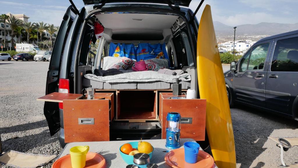 圣米格尔德阿沃纳EndlessCamperVan的一辆面包车,门开,床和冲浪板