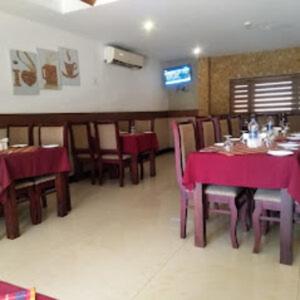 帕拉克卡德Kottaram Hotels Ottaplam的用餐室配有桌椅和紫色桌布